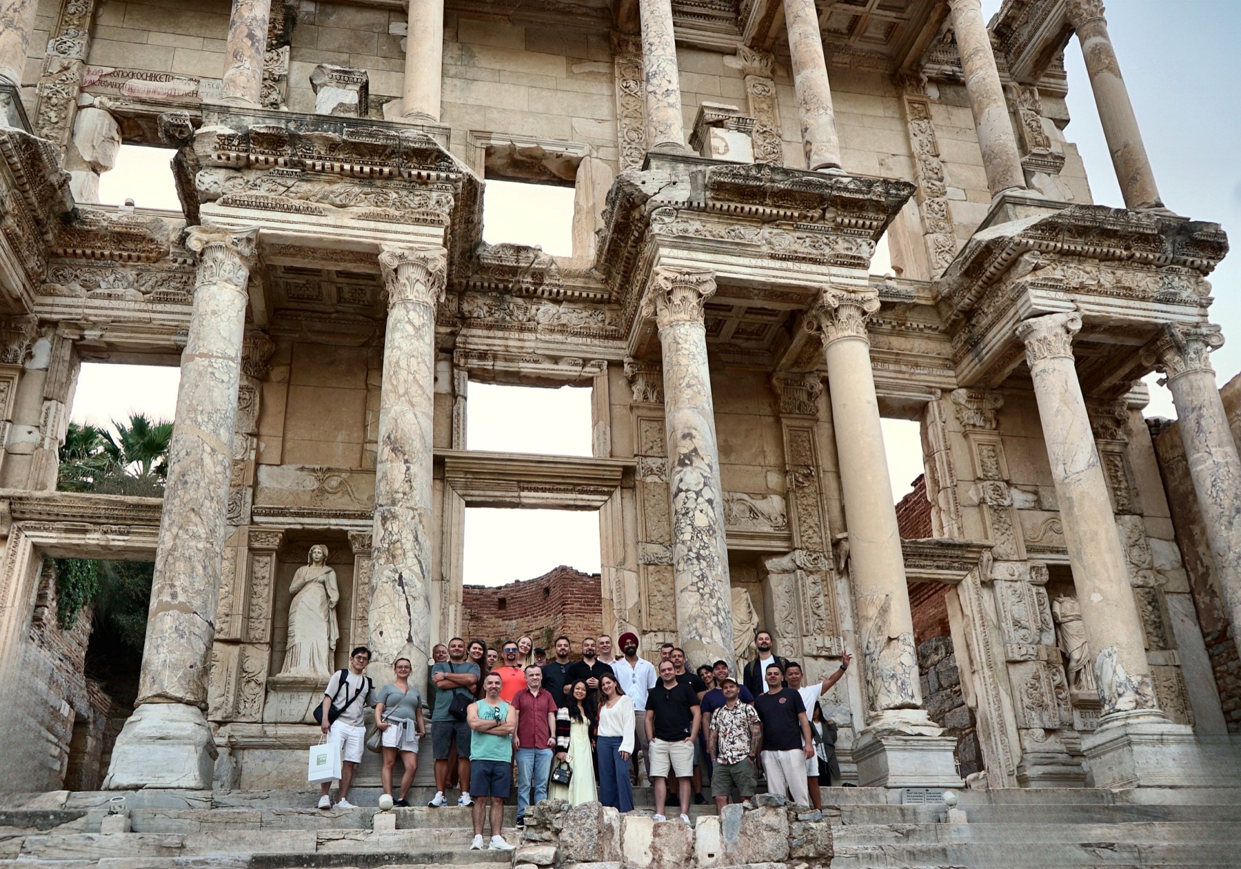 Holistic SEO Mastermind attendees gathered in front of the Library of Celsus at Ephesus