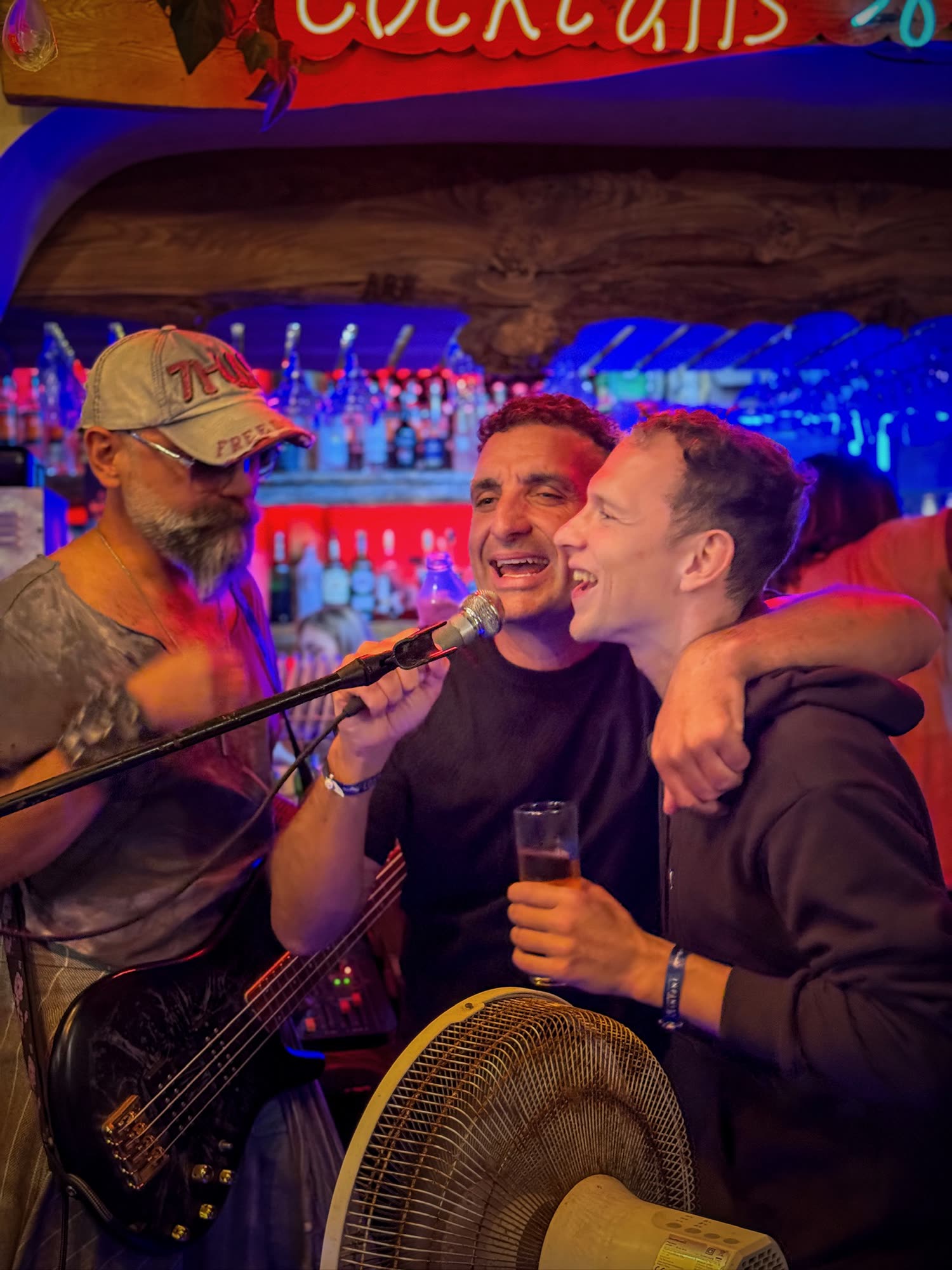 Holistic SEO Mastermind attendees singing and laughing together during an evening in Kuşadası