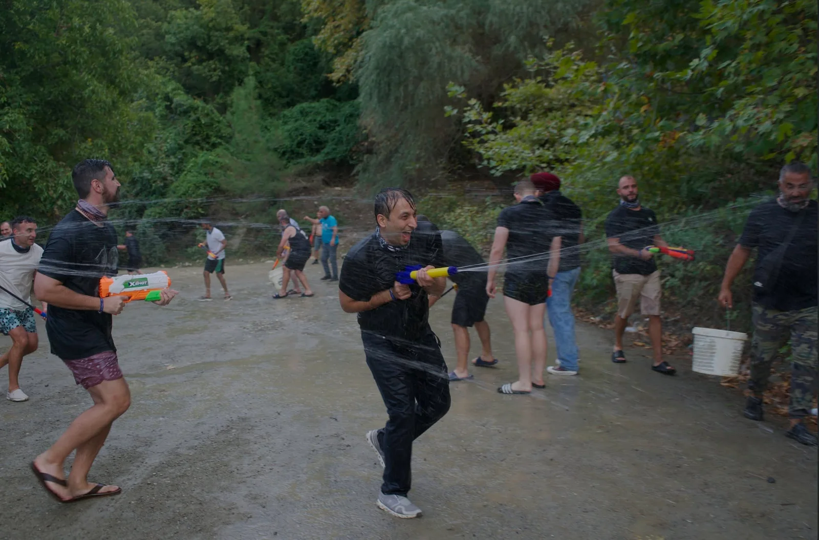 Mastermind attendees playing with water pistols outdoors