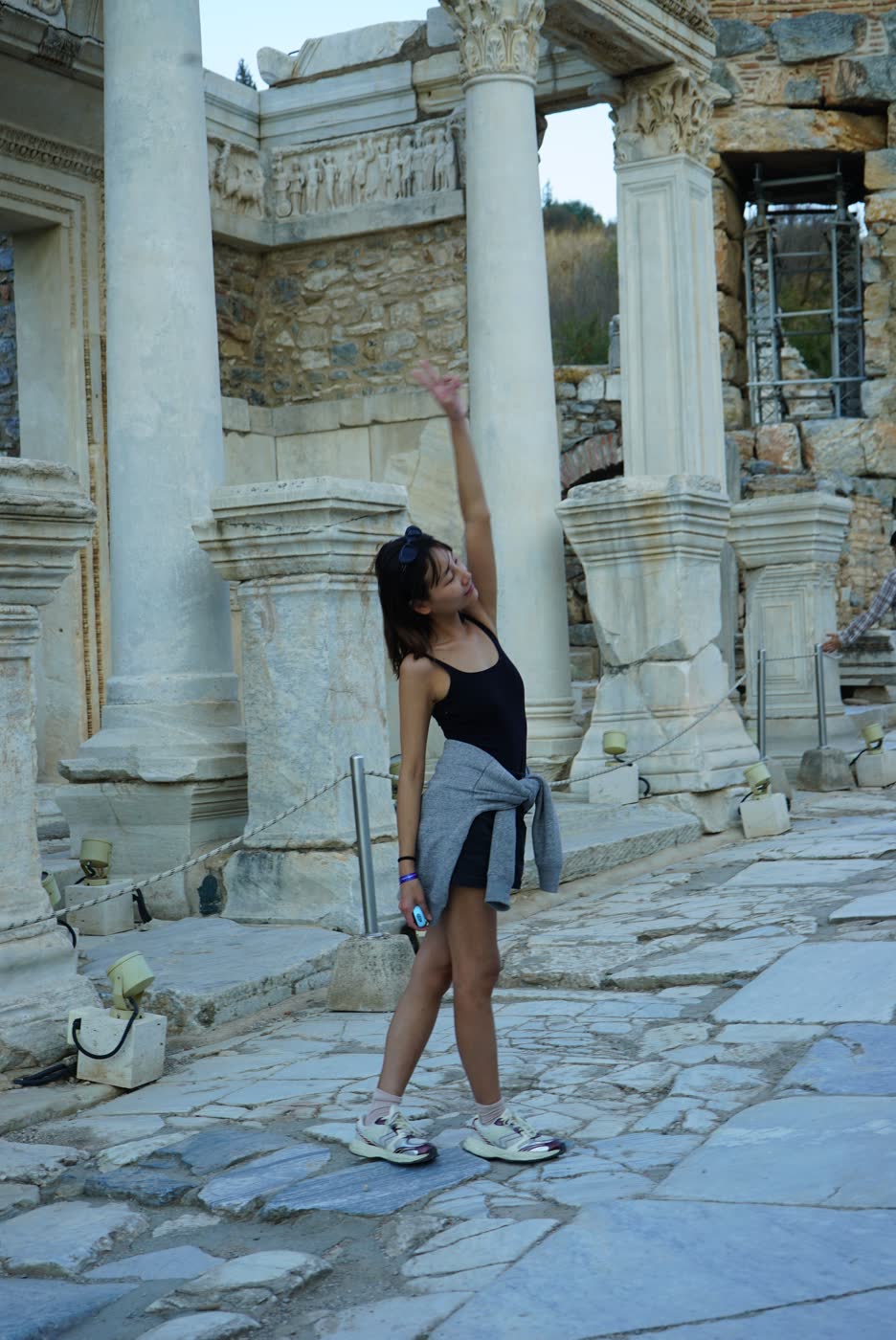 An attendee enjoying a playful moment among the ruins of Ephesus