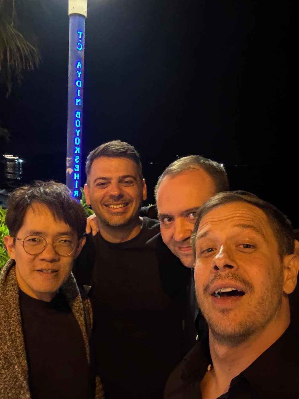 Four attendees sharing a relaxed evening together