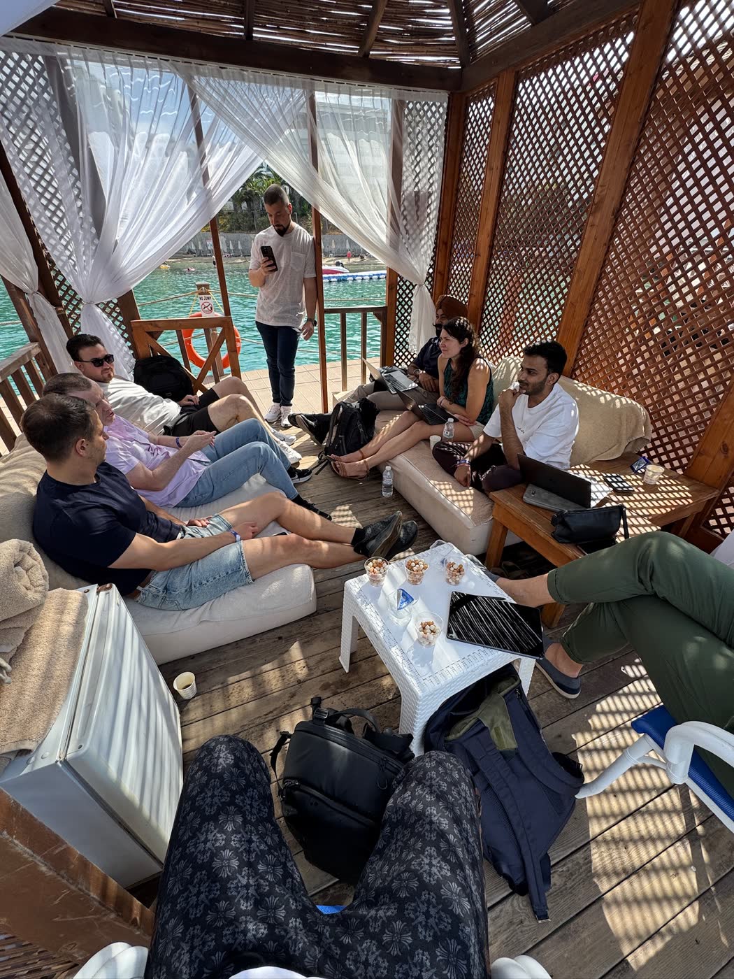 A small working group exchanging ideas beside the water